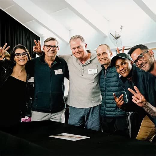 A group of people smiling and posing for a photo indoors.